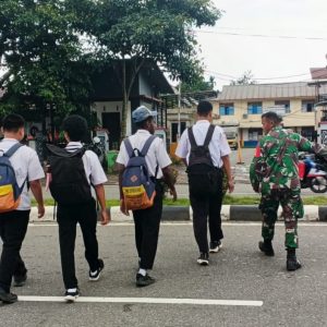 Peduli Keselamatan Anak Sekolah, Secara Rutin Babinsa Koramil Jajaran Kodim 1710/Mimika Bantu Seberangkan Jalan